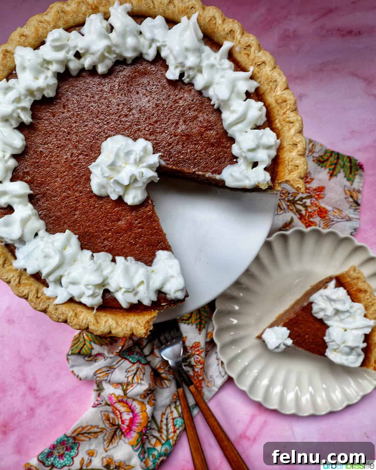 A slice of warm cinnamon pie with a dollop of whipped cream on a pink background.
