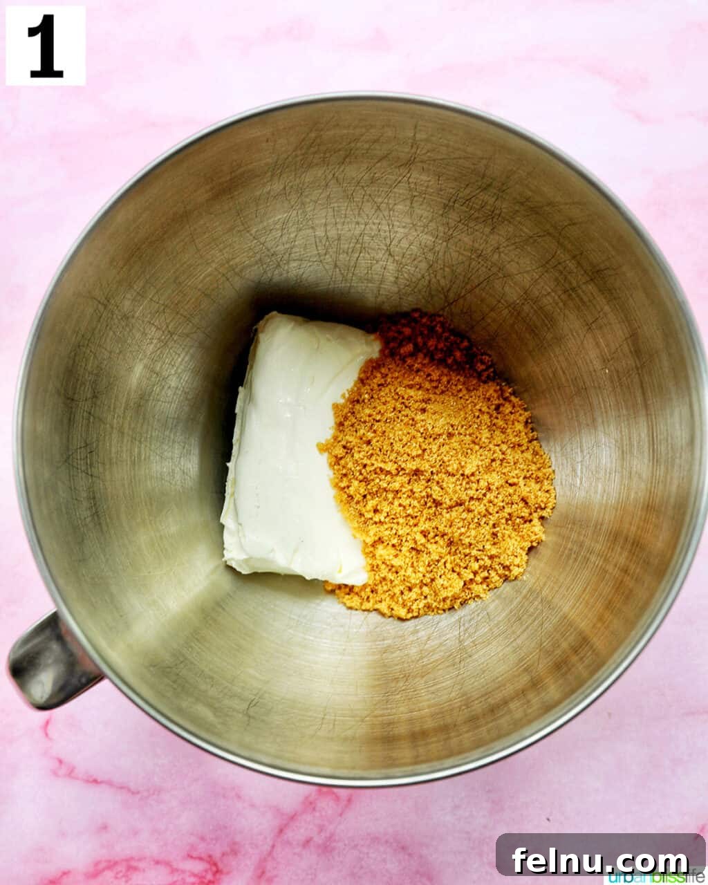Brown sugar and cream cheese being beaten together in a stand mixer.