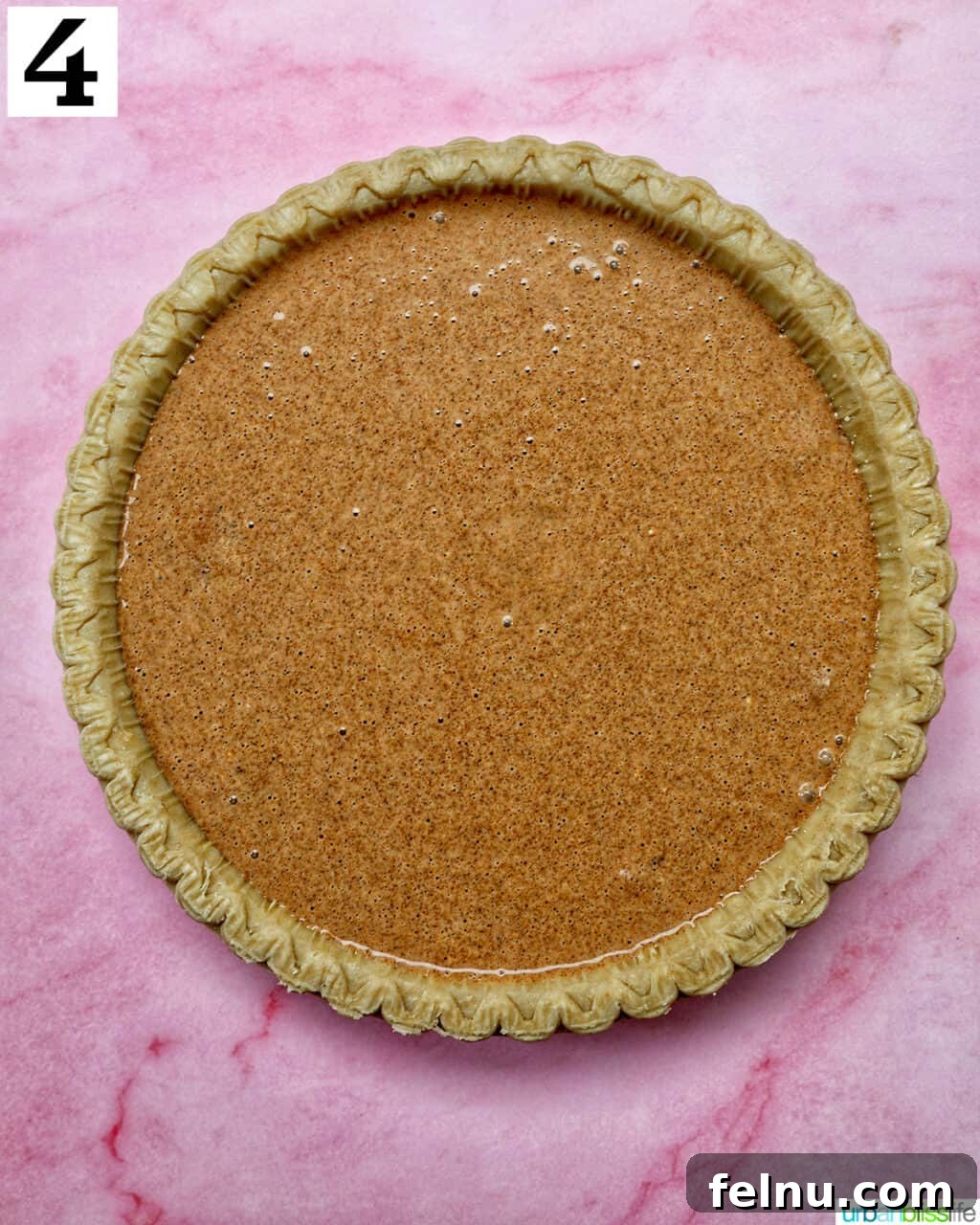 Cinnamon pie filling poured into a pie crust.
