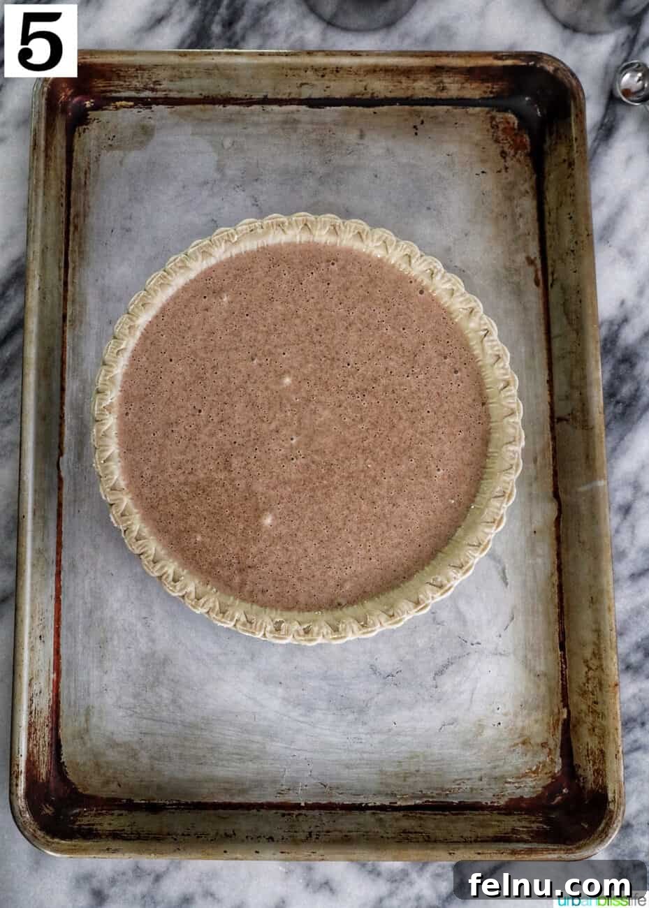 Cinnamon pie on a baking sheet, ready for the oven.
