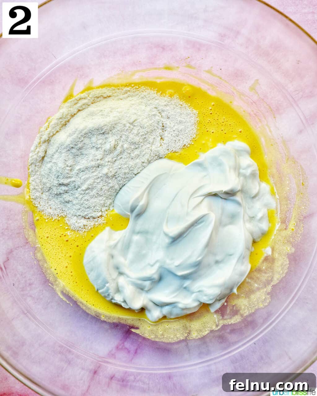 Decadent Dairy-Free Tiramisu 8 Instant pudding mix and coconut cream added over the whisked egg yolks in a clear glass bowl.