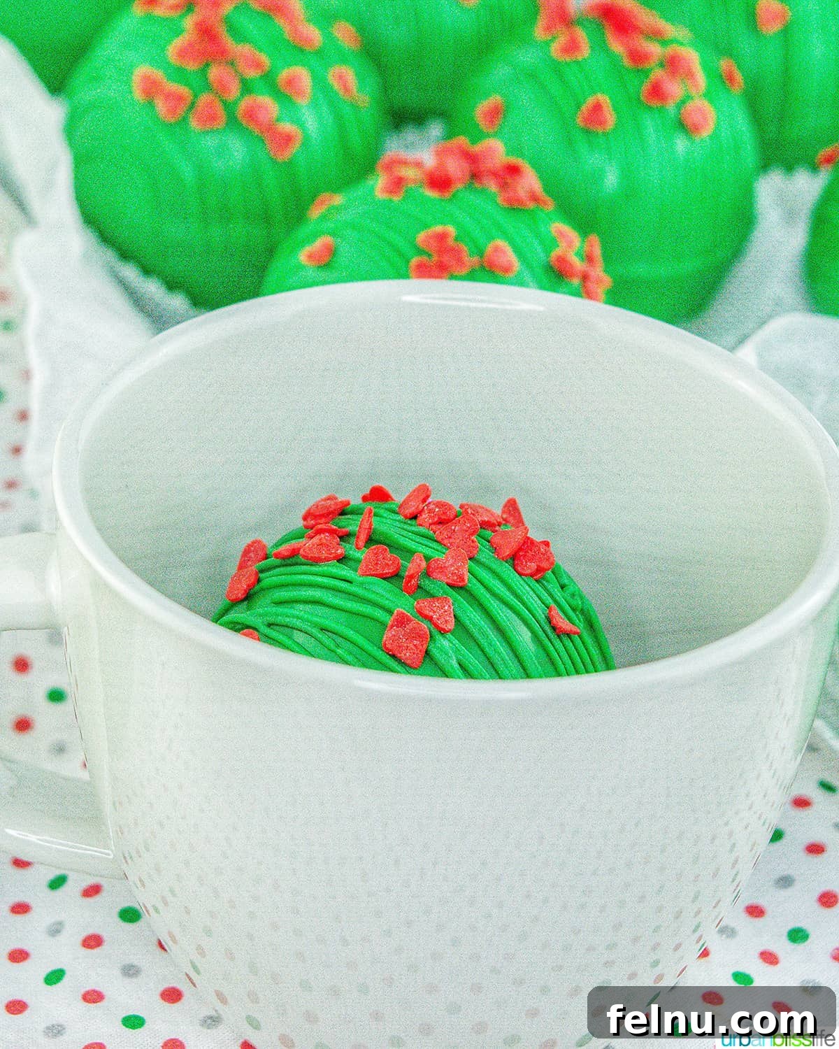 Grinch Hot Chocolate Bomb melting in a cup