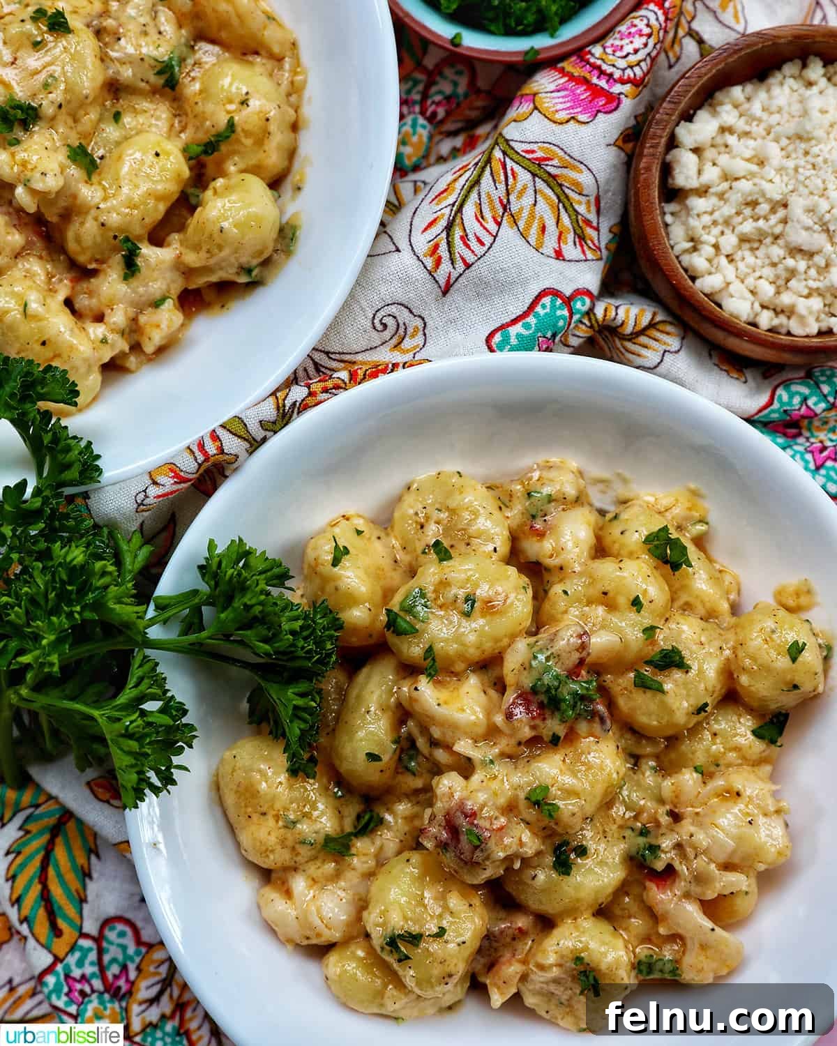 Decadent Lobster Gnocchi 15 Two bowls of creamy lobster gnocchi, overhead shot, with fresh herbs and garnishes on the side, highlighting a complete meal.