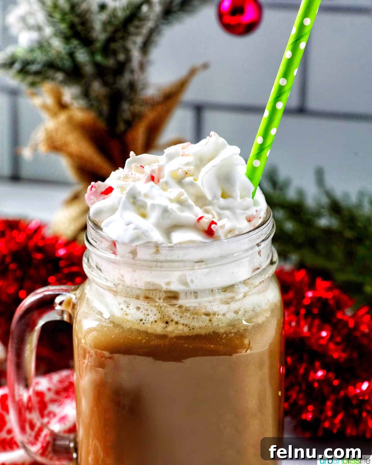 Close-up of White Chocolate Peppermint Mocha with whipped cream and straw