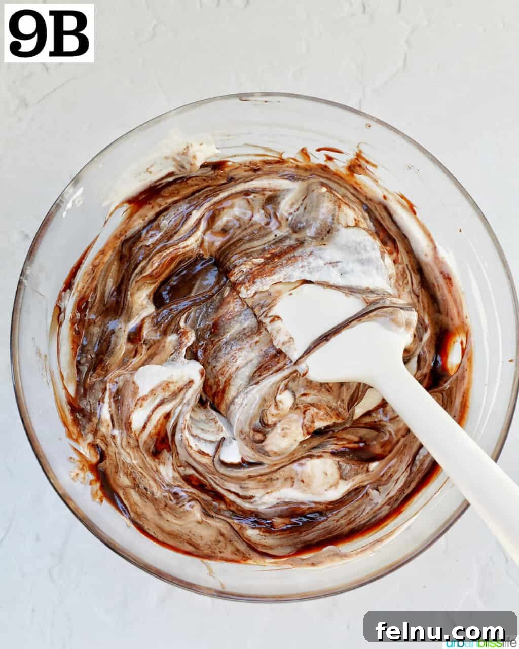 Cool Mint Chocolate Indulgence 14 Continuing to fold whipped cream into the chocolate base in a glass bowl, carefully combining the two for a smooth filling.