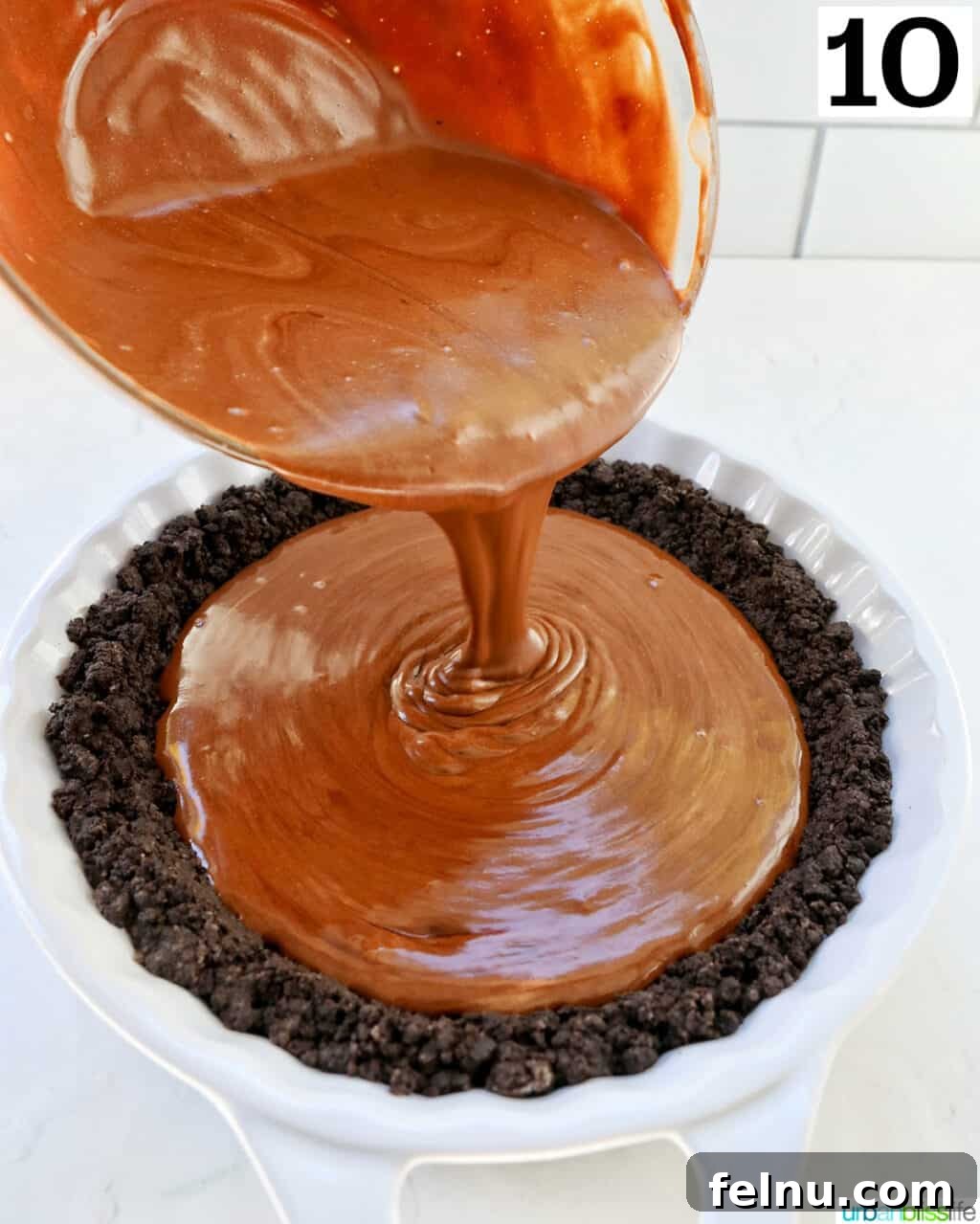 Cool Mint Chocolate Indulgence 16 Pouring the creamy chocolate peppermint pie filling into the pre-baked Oreo cookie crust in a pie dish.