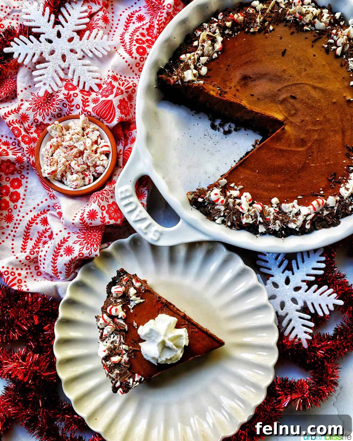 Cool Mint Chocolate Indulgence 19 A tempting slice of Chocolate Peppermint Pie presented on a scalloped plate, accompanied by the whole pie and a bowl of festive peppermint candies.