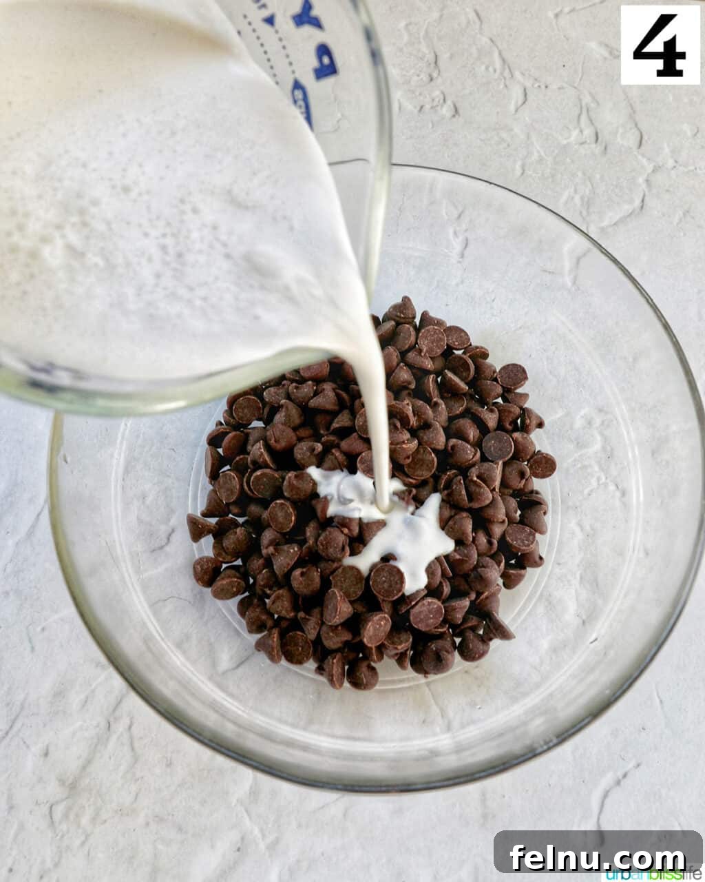 Cool Mint Chocolate Indulgence 8 Heavy cream being poured over a glass bowl filled with semi-sweet chocolate chips, setting the stage for the rich pie filling.