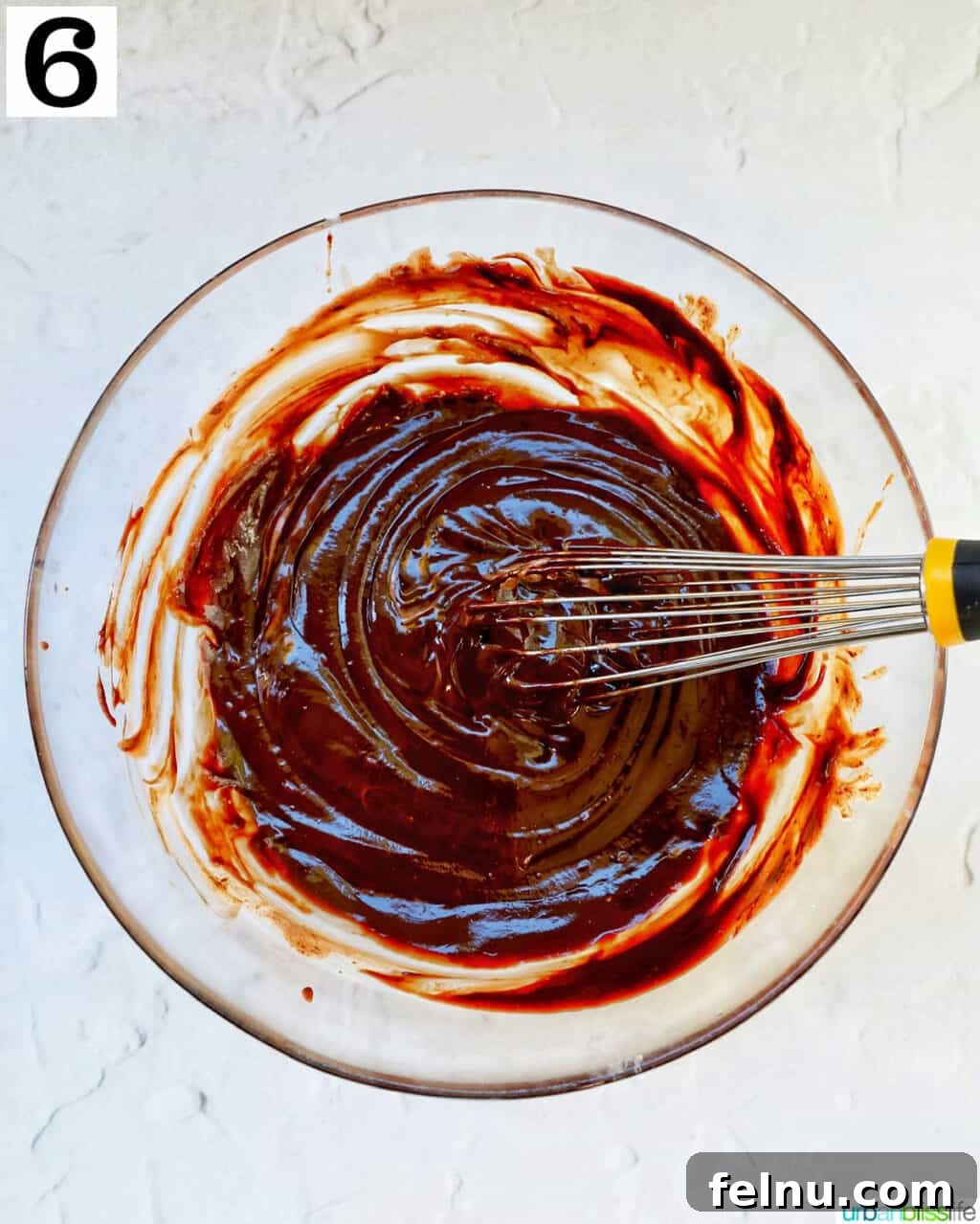 Cool Mint Chocolate Indulgence 10 A whisk expertly blending melted chocolate and cream until perfectly smooth and glossy, forming the decadent base for the pie filling.