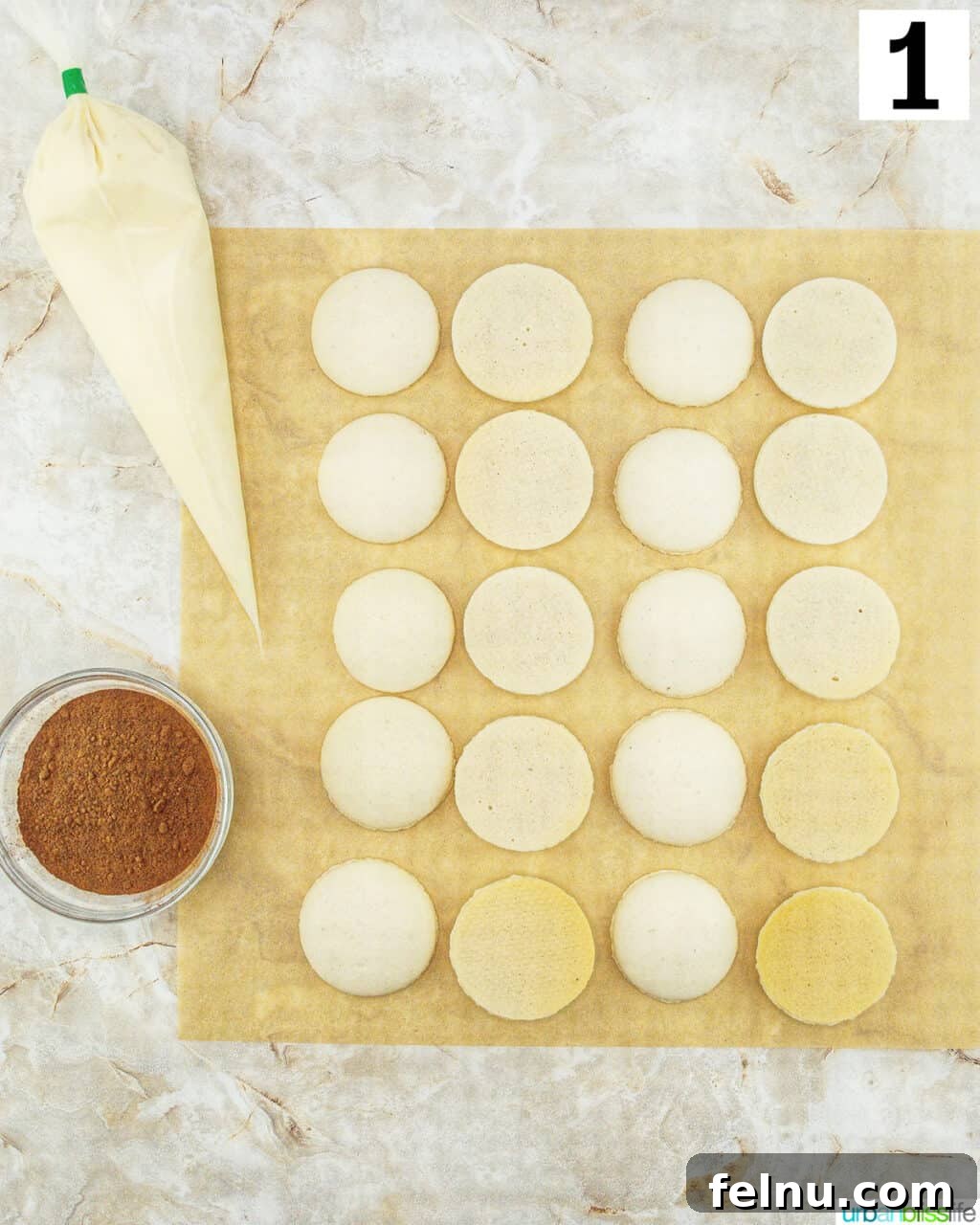 Espresso Mascarpone Macarons 19 A piping bag filled with tiramisu cream next to macaron cookie shells.