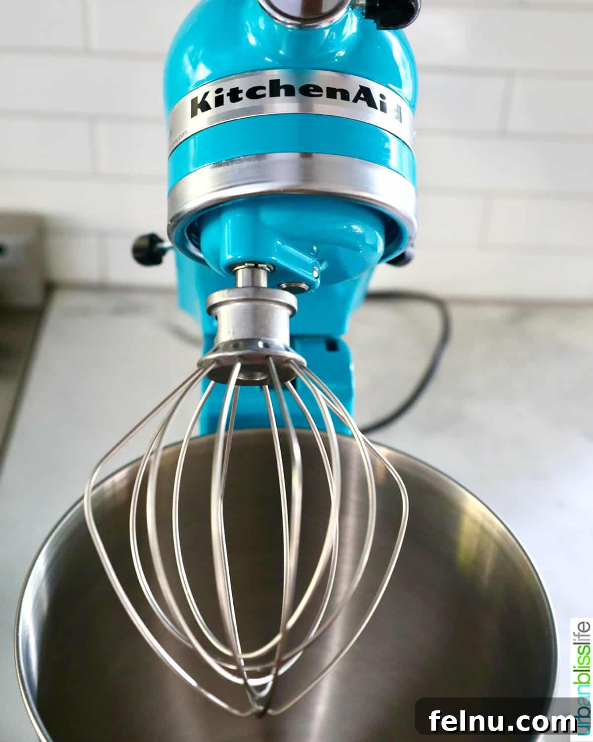 Your Stress-Free Thanksgiving Guide 9 aqua blue Kitchenaid stand mixer with whisk attachment.