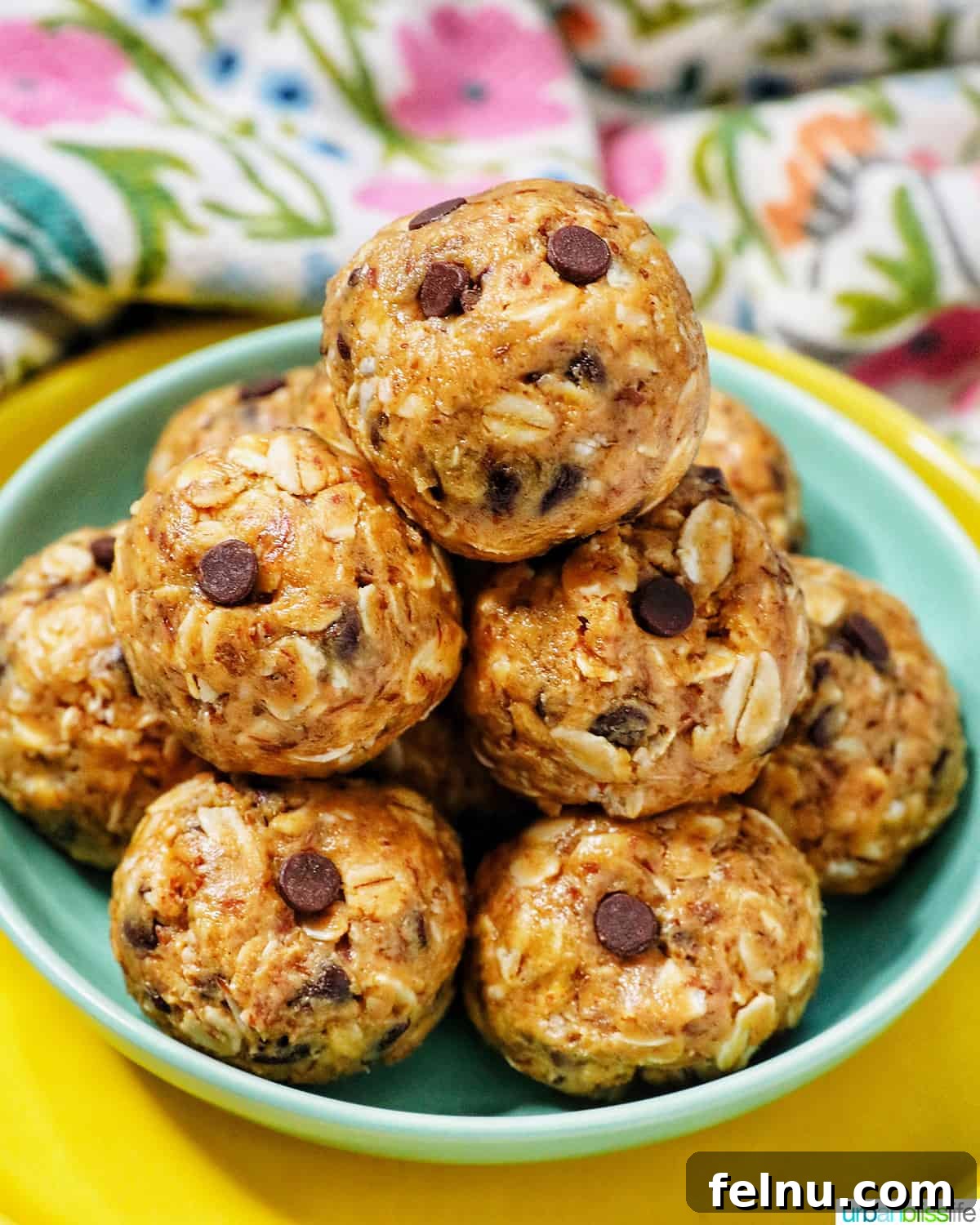 Chewy Peanut Butter Chocolate Chip Oat Bites 2 A stack of delicious Peanut Butter Chocolate Chip Oatmeal Balls on a vibrant green and yellow plate, ready to be enjoyed.