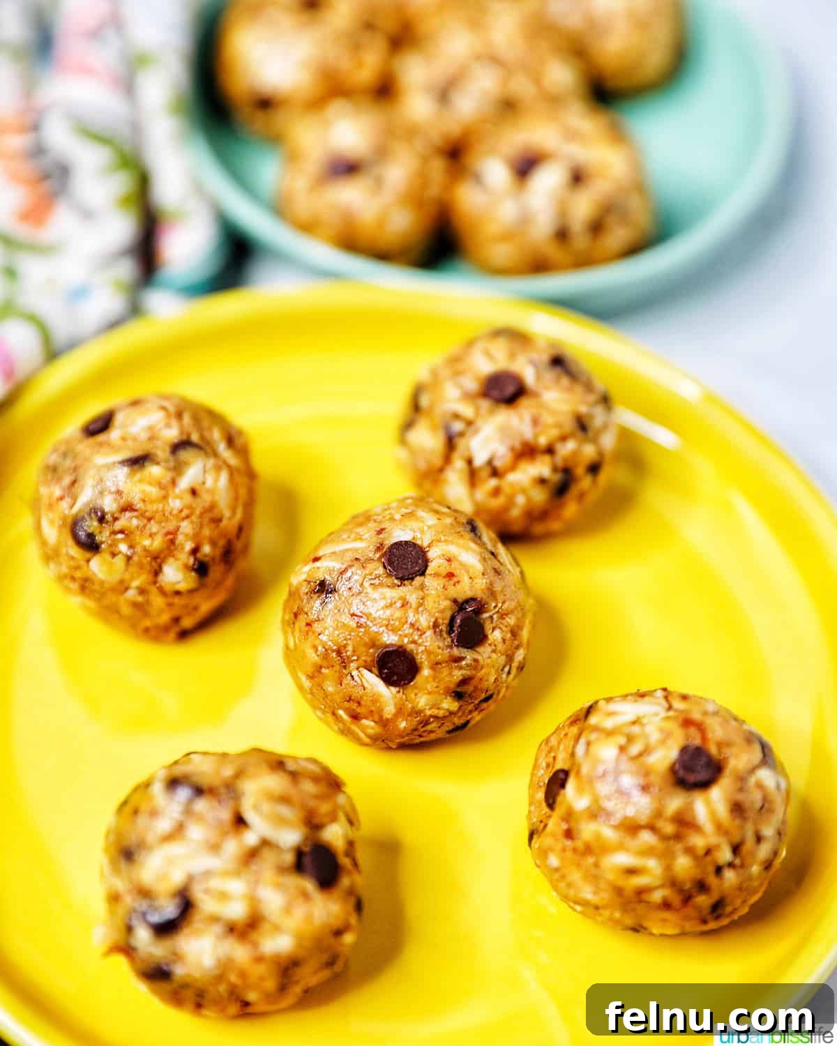 Chewy Peanut Butter Chocolate Chip Oat Bites 9 A vibrant yellow plate holds several perfectly formed Peanut Butter Chocolate Chip Oatmeal Balls, inviting to eat.