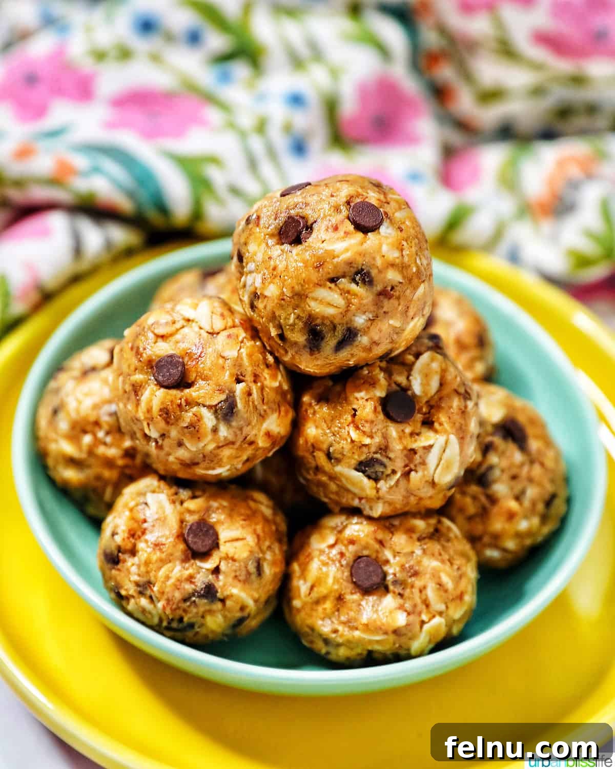 Chewy Peanut Butter Chocolate Chip Oat Bites 10 Another appealing stack of Peanut Butter Chocolate Chip Oatmeal Balls, perfectly presented on a green and yellow plate.