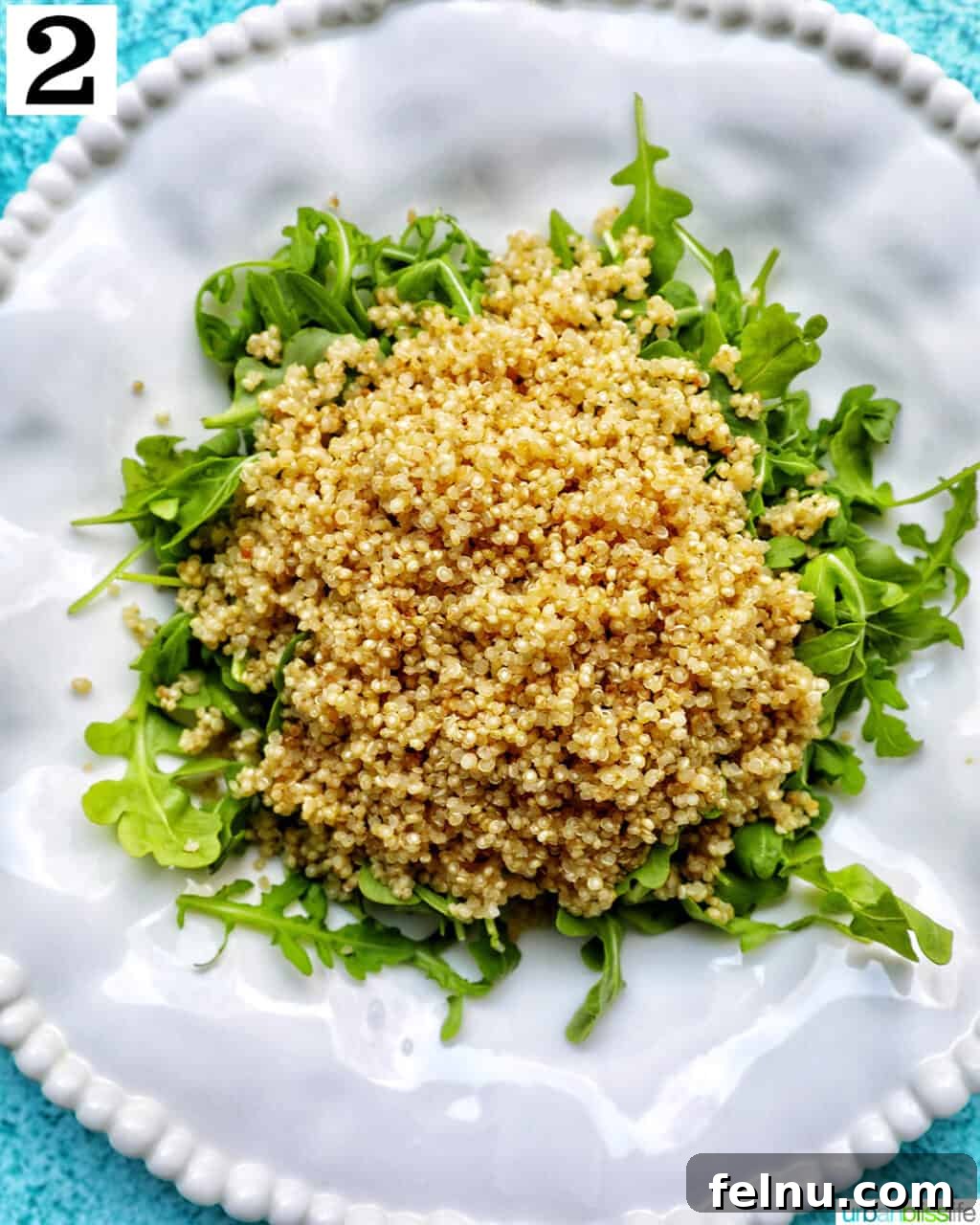 Vibrant Arugula Quinoa Harvest 7 white bowl with arugula and quinoa salad.