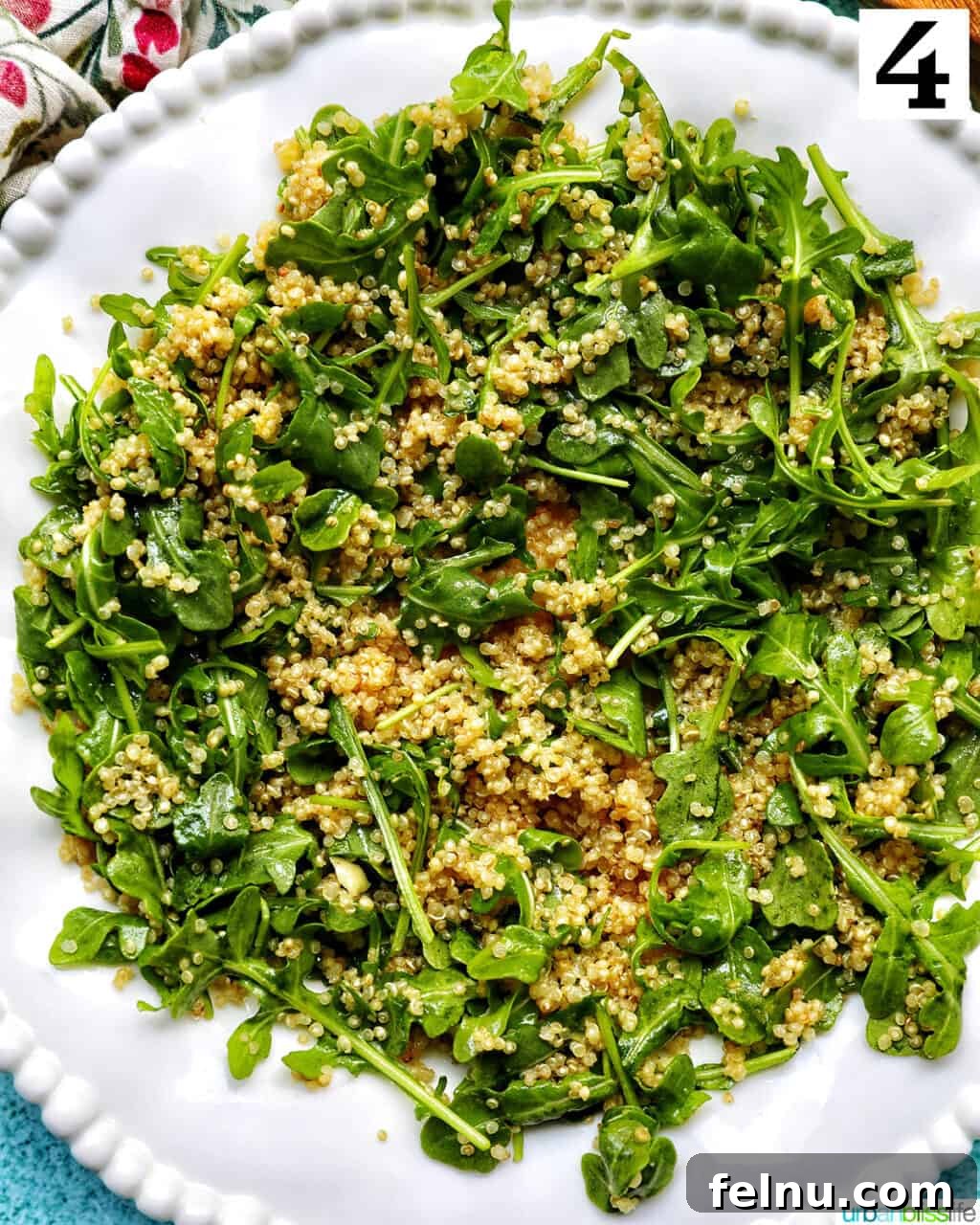 Vibrant Arugula Quinoa Harvest 9 white bowl with arugula and quinoa salad.