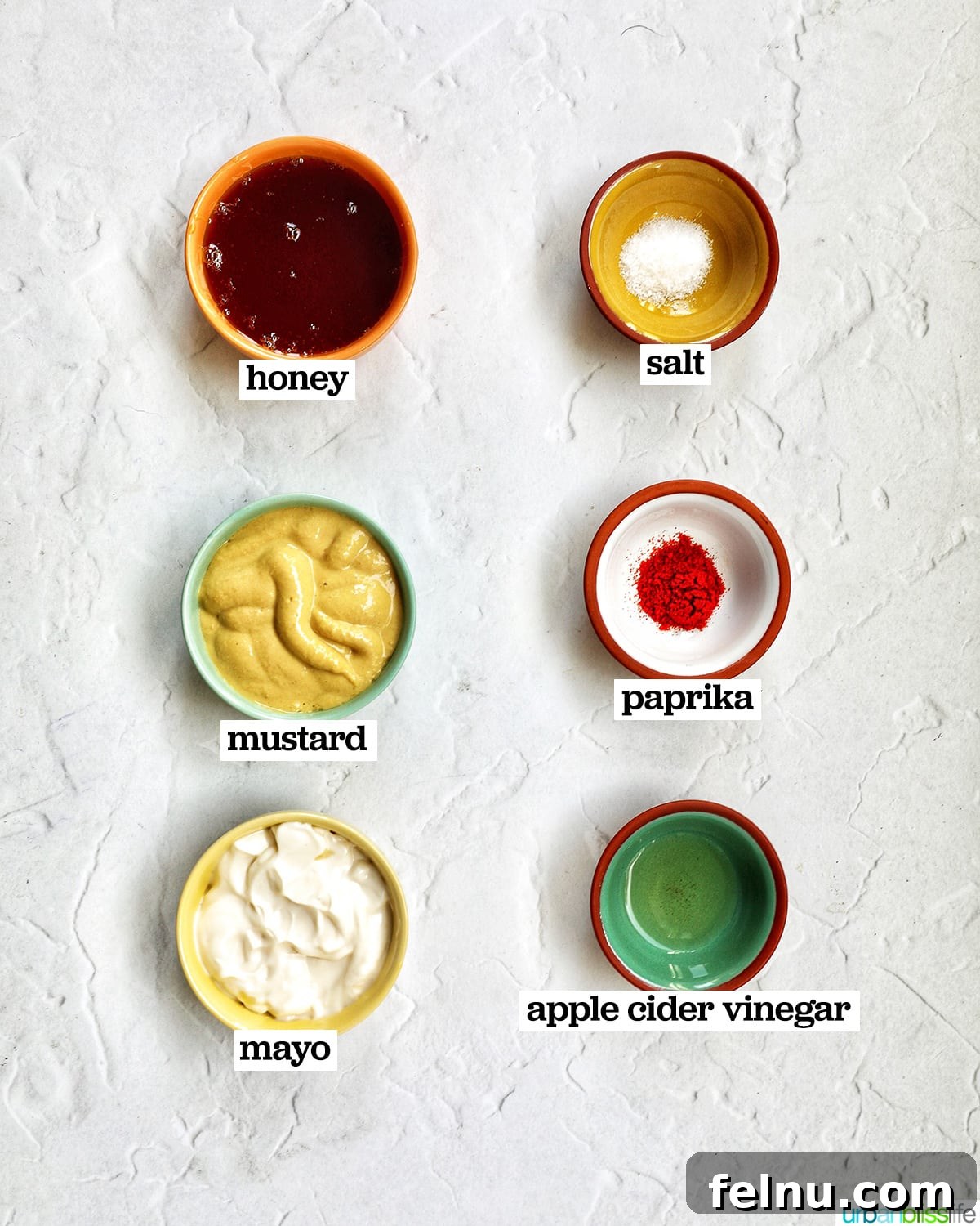 bowls of six ingredients to make honey mustard dipping sauce.