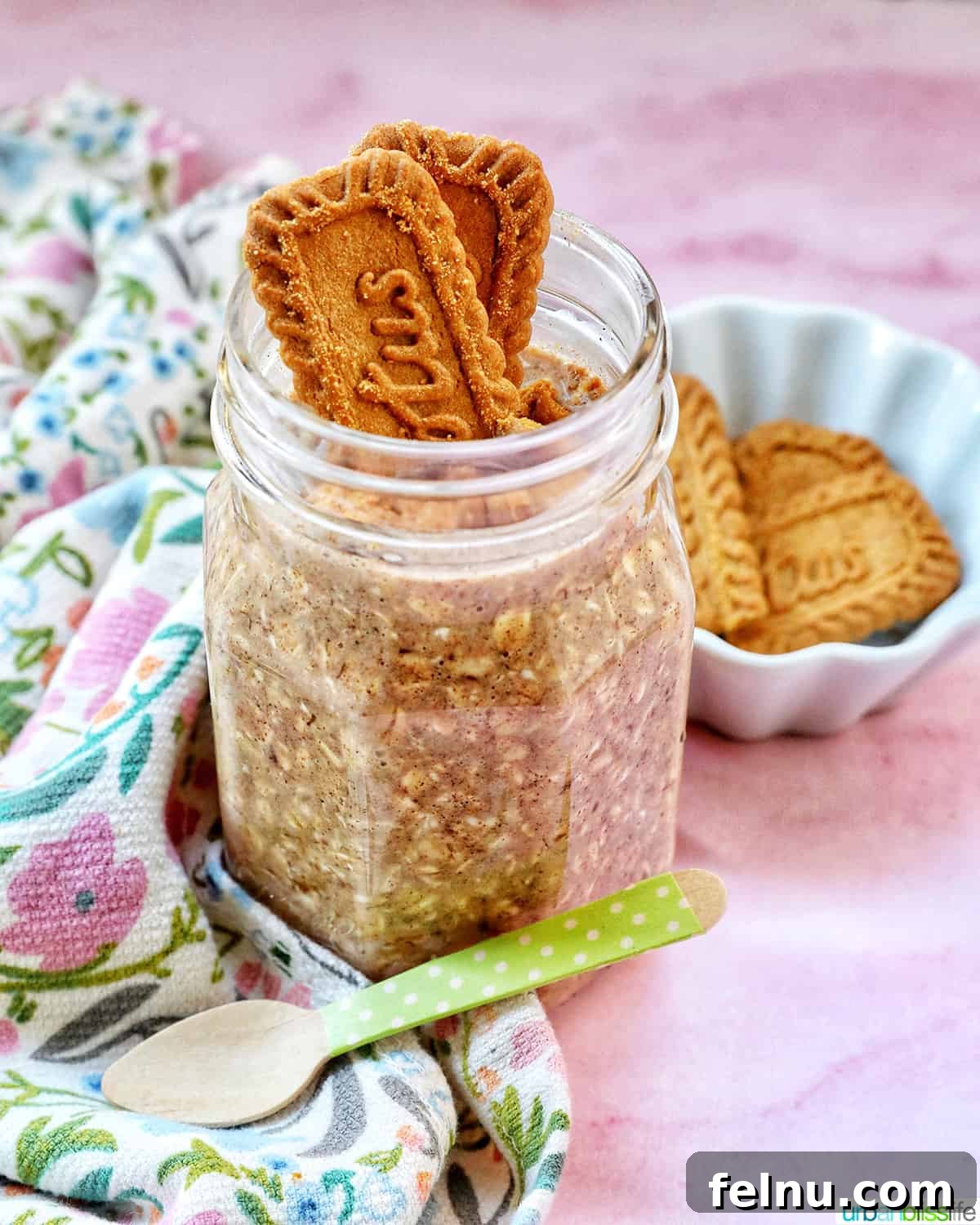 Biscoff overnight oats in a jar with crumbled Biscoff cookies on top.