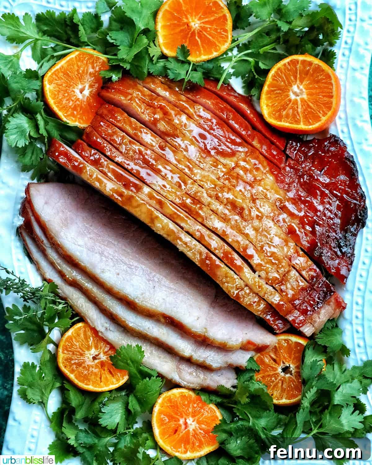 Air Fryer Ham Orijinal Başlık: Crispy & Quick: Air Fryer Ham Recipe 2 Air fryer ham sliced and glazed, garnished with herbs and oranges