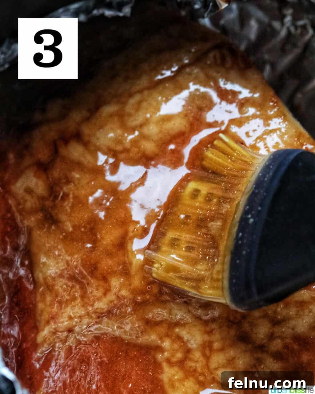 Air Fryer Ham Orijinal Başlık: Crispy & Quick: Air Fryer Ham Recipe 9 Basting brush brushing sweet glaze onto ham in an air fryer
