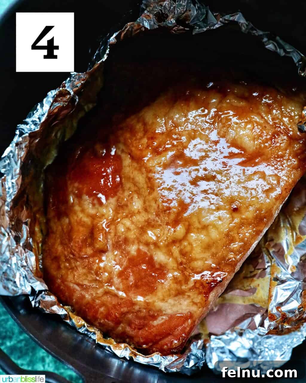 Air Fryer Ham Orijinal Başlık: Crispy & Quick: Air Fryer Ham Recipe 10 Glossy glazed ham in aluminum foil in an air fryer basket