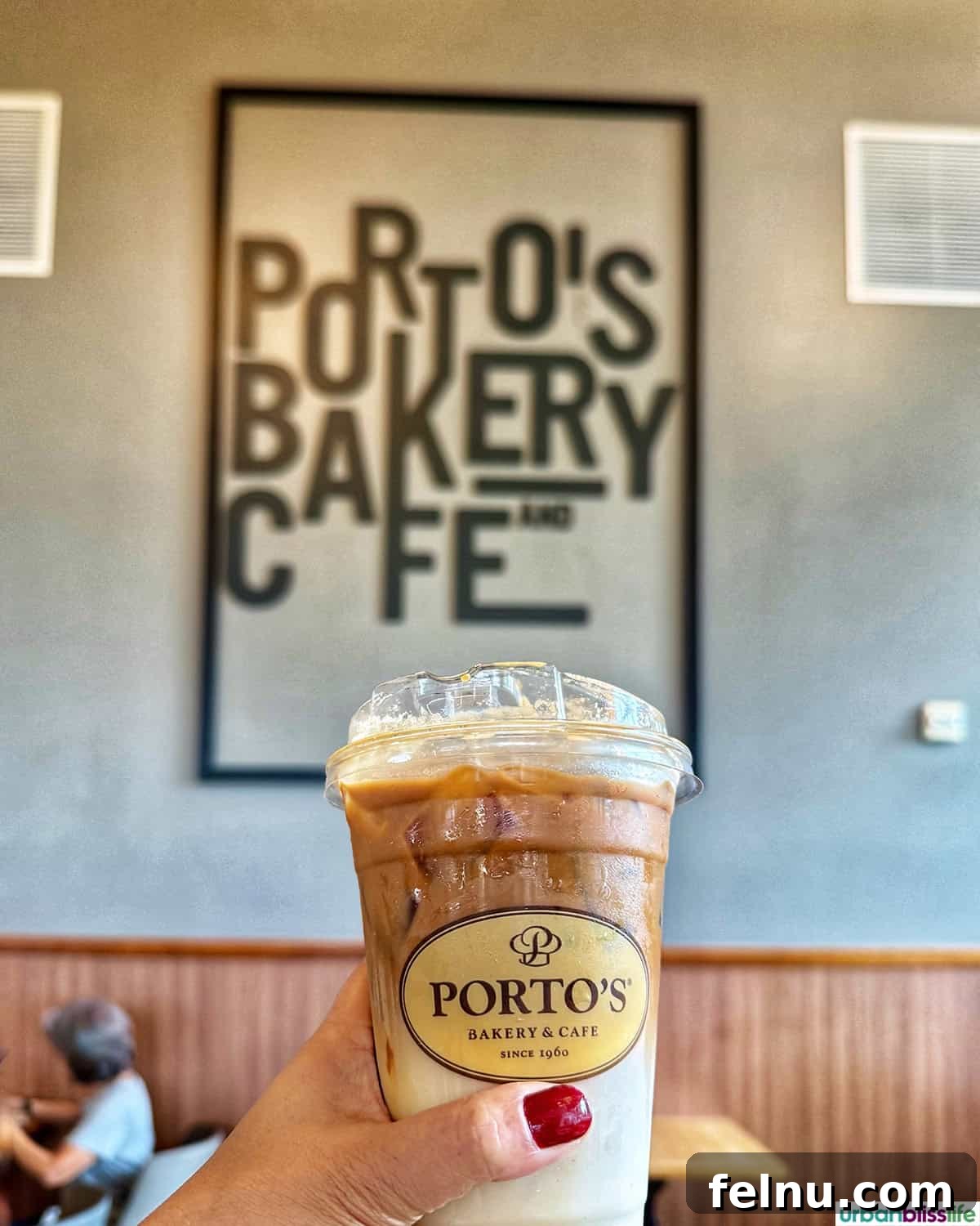 Dining Hotspots in Buena Park 28 An iced coffee in front of the Porto's Bakery Cafe sign in Buena Park, California.