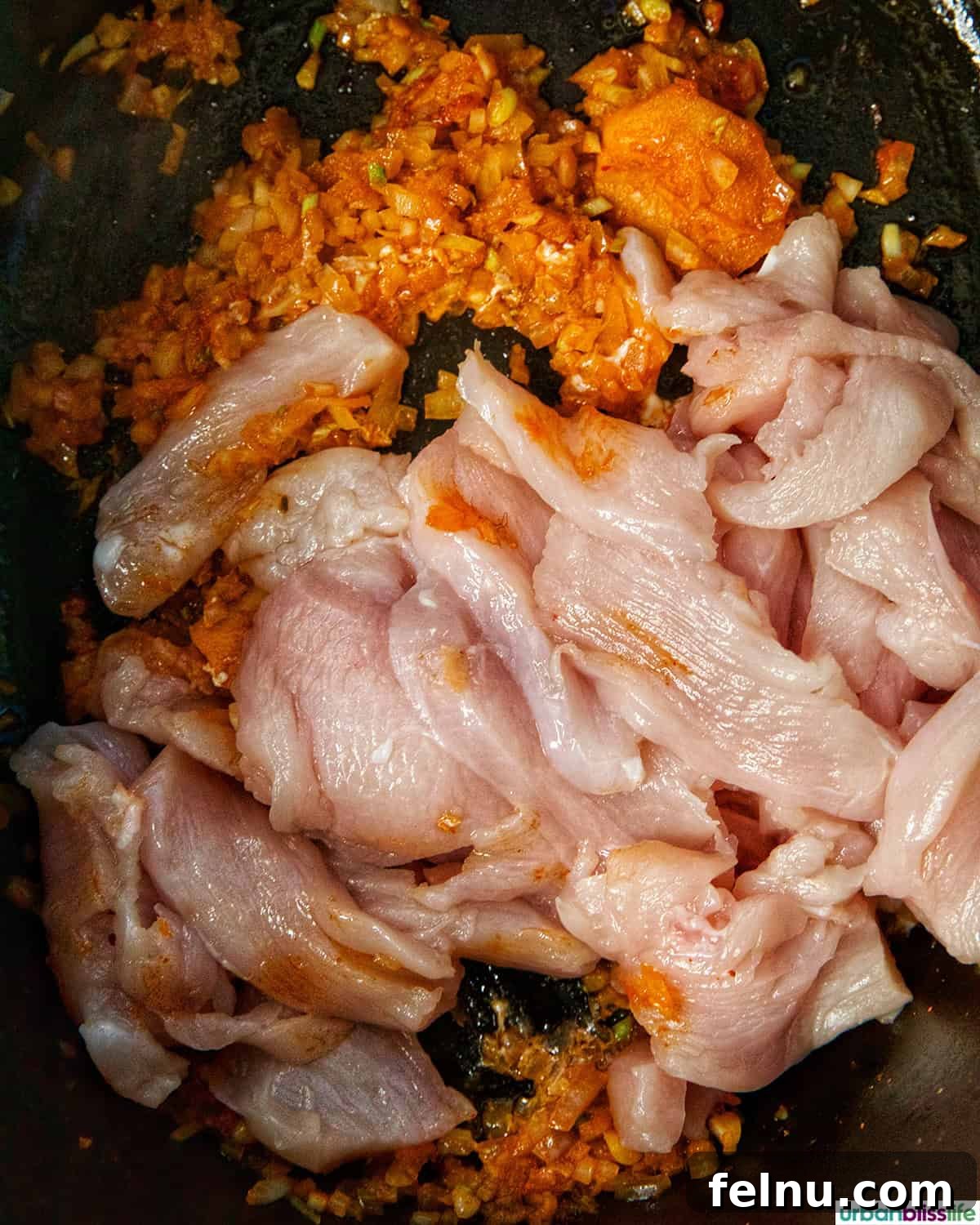 Chicken cooking with aromatics
