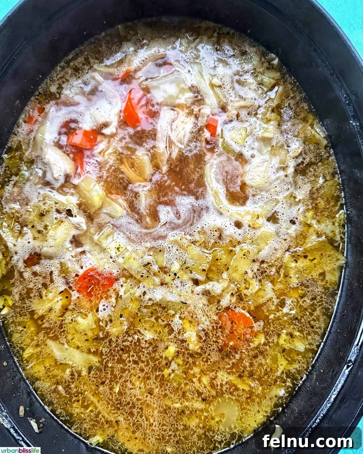Chicken cabbage soup cooking in a Dutch oven.