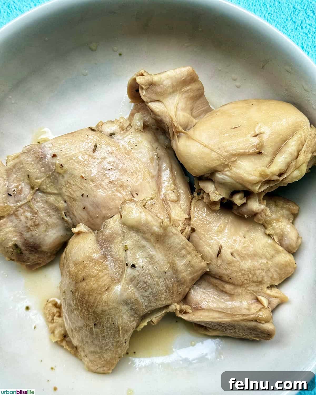 Cooked chicken breasts in a bowl.
