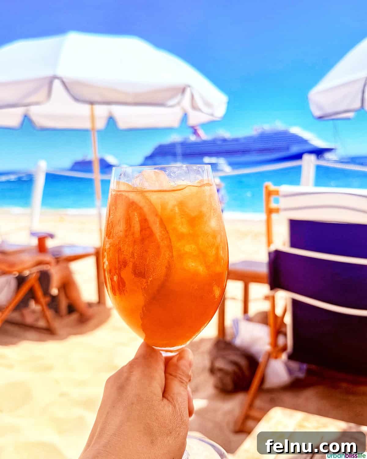 Dining Delights in Cabo: A Culinary Adventure 24 Hand holding an aperol spritz at SUR Beach House in Cabo San Lucas, Mexico.