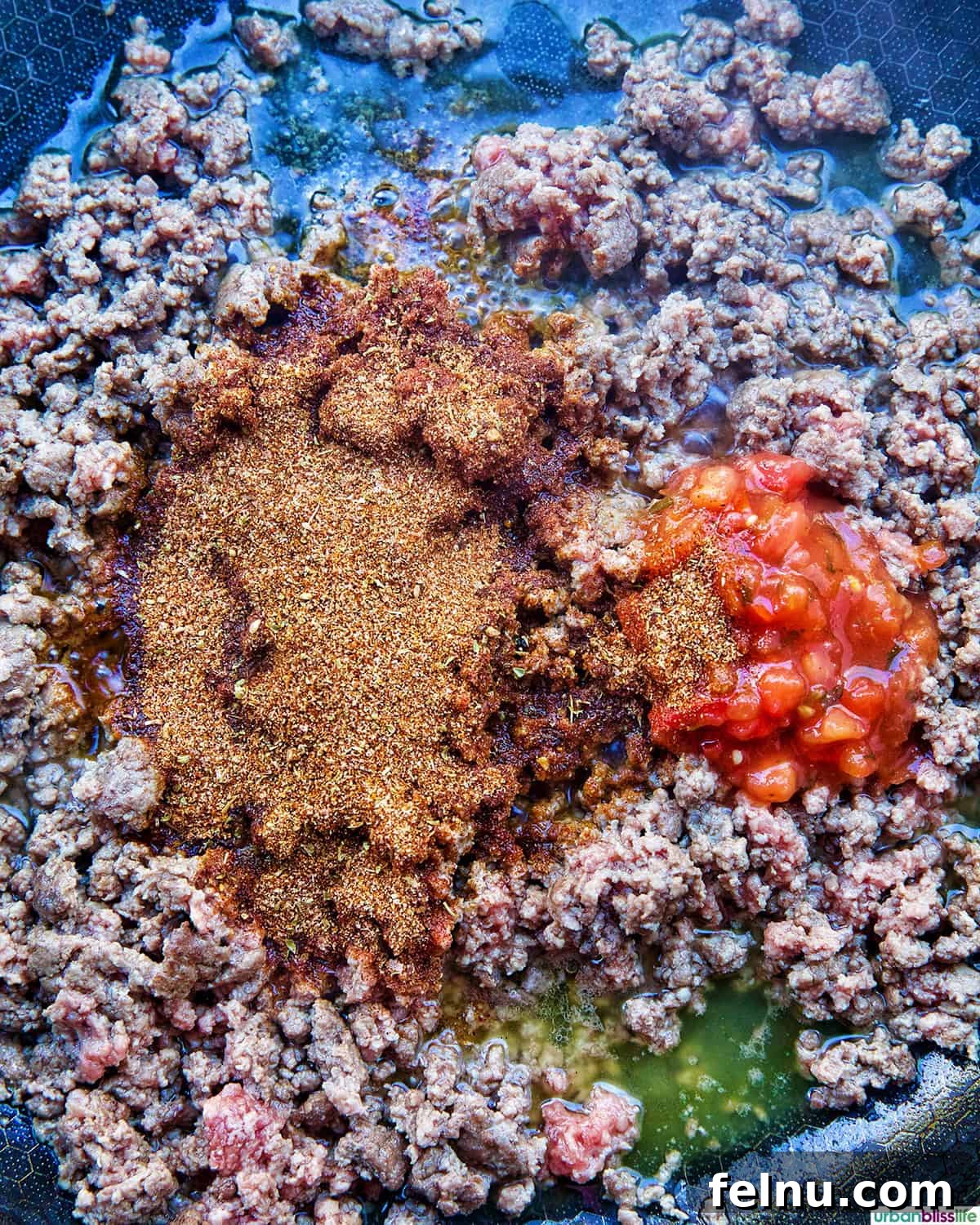 Golden-Crisp Beef Tacos 8 Taco seasoning and salsa being stirred into the browned ground beef in a skillet.