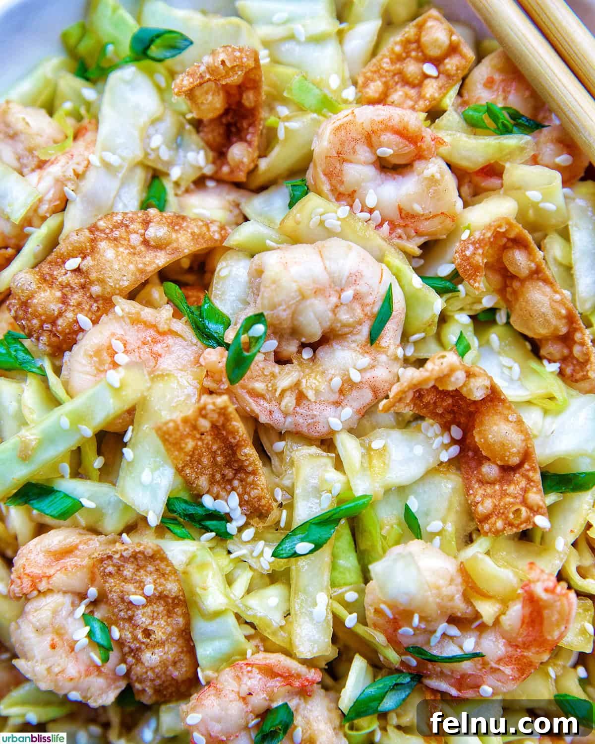 A vibrant bowl of cabbage and shrimp stir fry, visually appealing and ready to be topped.