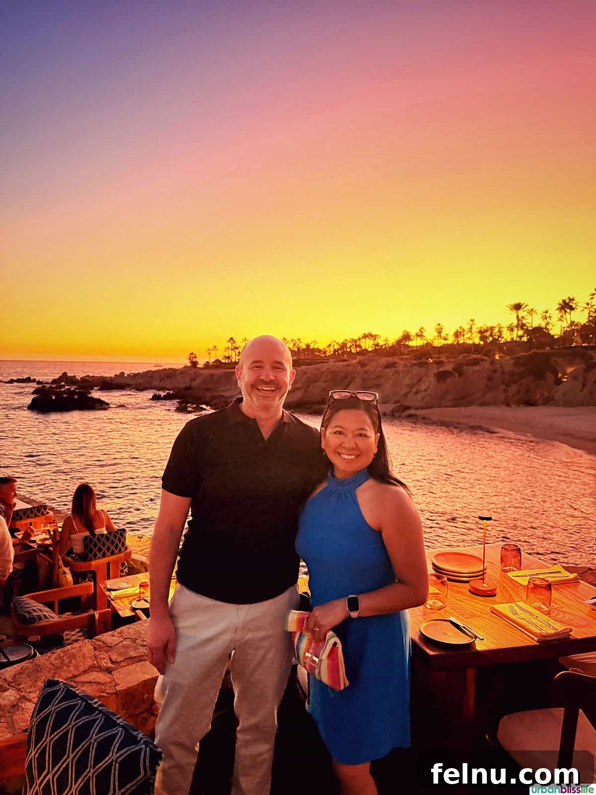 Cocina del Mar: Oceanfront Dining in Cabo San Lucas, Mexico 16 Marlynn Jayme Schotland and Alain Schotland standing with the sea and sunset in background at Cocina del Mar restaurant in Cabo San Lucas, Mexico.