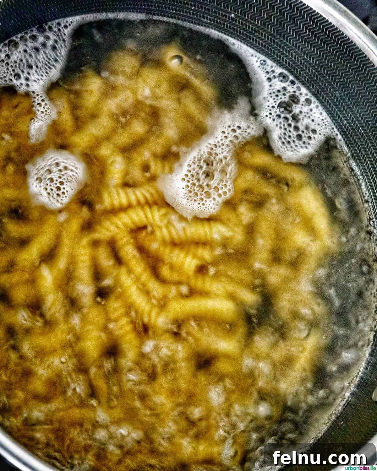 Creamy Caesar Pasta Salad with Crispy Croutons 6 pasta boiling in a pot of water.