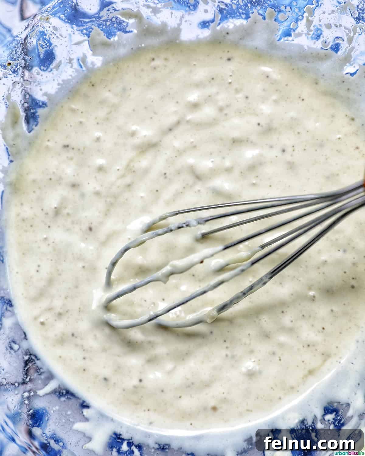 Creamy Caesar Pasta Salad with Crispy Croutons 8 whisk and bowl of Caesar dressing.