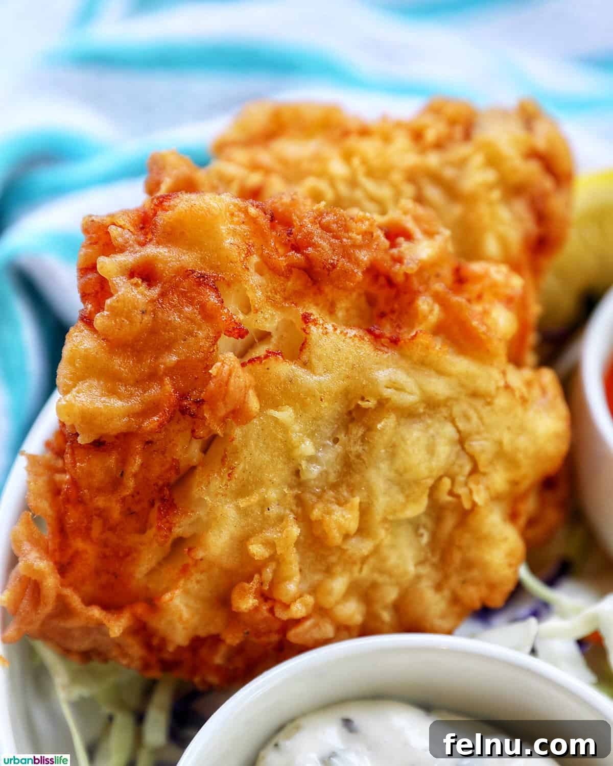 Crispy Air Fryer Cod with Lemon Garlic Butter 3 air fryer cod pieces on a plate.